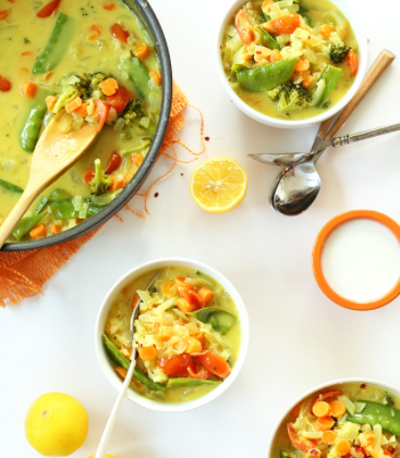 picture of vibrant vegetable dish in a pot along with sevings in separate bowls